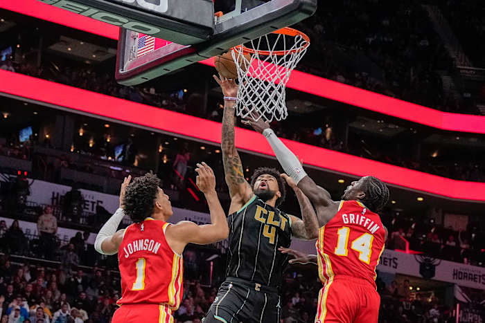 Hornets center Nick Richards shoots over Hawks forwards Jalen Johnson and AJ Griffin.